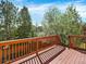Enjoy the view from the wooden deck overlooking lush greenery and mature trees, creating a peaceful outdoor retreat at 8380 Blackgum St, Parker, CO 80134