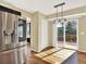 A naturally lit dining area with stainless steel fridge and sliding doors to an outdoor deck at 8380 Blackgum St, Parker, CO 80134