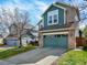 Beautifully designed home with a large two-car garage, brick pillars, and a well-groomed lawn at 8380 Blackgum St, Parker, CO 80134