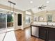 Bright kitchen with stainless steel appliances, dark cabinets, and access to the outdoor deck at 8380 Blackgum St, Parker, CO 80134