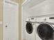 A well-organized laundry room with white front-load machines and ample storage shelves at 8380 Blackgum St, Parker, CO 80134