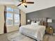 A spacious primary bedroom with a ceiling fan, neutral tones, and large windows at 8380 Blackgum St, Parker, CO 80134