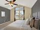 A spacious primary bedroom featuring vaulted ceiling, ceiling fan, large windows and neutral tones at 8380 Blackgum St, Parker, CO 80134