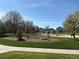 Community playground with diverse equipment surrounded by grassy areas and landscaping at 8380 Blackgum St, Parker, CO 80134