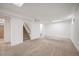 Spacious basement features neutral carpet, stairs, and access to other rooms in the house at 7987 Durango St, Denver, CO 80221