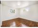 Bedroom with hardwood floors and bright light from two windows at 7987 Durango St, Denver, CO 80221