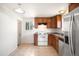 Traditional style kitchen with wood cabinets, tile flooring, and a window offering natural light at 7987 Durango St, Denver, CO 80221