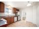 Functional kitchen with wood cabinets, stainless steel appliances, and a view into an adjacent room at 7987 Durango St, Denver, CO 80221