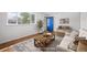 Bright living room showcasing a cozy sofa, wooden coffee table, and a blue front door at 7987 Durango St, Denver, CO 80221