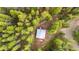 A scenic aerial shot of a cabin surrounded by lush green trees and mountain views at 154 Apache Rd, Evergreen, CO 80439