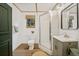 Well-lit bathroom featuring a toilet, walk-in shower and framed window with wooden floors at 154 Apache Rd, Evergreen, CO 80439