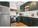 Stylish kitchen features dark cabinetry, stainless steel appliances, and bright countertops at 154 Apache Rd, Evergreen, CO 80439