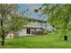 A backyard of a two-story home surrounded by lush greenery, a fence, and a cozy patio area with sliding doors at 4140 Monroe Dr # C, Boulder, CO 80303