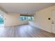 A spacious living room featuring modern flooring, a well-lit space with a window, and an open door at 4140 Monroe Dr # C, Boulder, CO 80303
