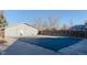 Community pool area with the pool closed during off season with a building and fence around the area at 4140 Monroe Dr # C, Boulder, CO 80303