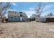 Expansive backyard with a fire pit area, perfect for entertaining, and featuring a functional storage shed at 3095 W Harvard Ave, Denver, CO 80219