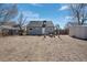 A spacious backyard featuring a fire pit area, complemented by well-maintained fencing and a storage shed at 3095 W Harvard Ave, Denver, CO 80219