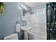 This bathroom features a classic pedestal sink, blue walls and a shower and tub combo at 3095 W Harvard Ave, Denver, CO 80219