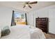 Serene bedroom with ceiling fan and natural light, showcasing comfort and style at 3095 W Harvard Ave, Denver, CO 80219