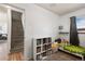 Well-lit bedroom featuring carpet, a cozy bed, and a built-in bookcase at 3095 W Harvard Ave, Denver, CO 80219