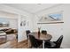 Charming dining area featuring hardwood floors and a view to the exterior at 3095 W Harvard Ave, Denver, CO 80219