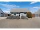 Charming single-story home with gray siding, complemented by mature landscaping and a well-maintained lawn at 3095 W Harvard Ave, Denver, CO 80219