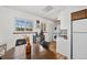 Bright and efficient kitchen with white cabinetry, adjacent table and side-by-side washer and dryer at 3095 W Harvard Ave, Denver, CO 80219