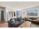 Living room with comfortable seating, built-in shelving and an abundance of natural light at 3095 W Harvard Ave, Denver, CO 80219