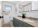 Bright bathroom with double sinks, granite countertops, and decorative mirror at 7216 S Lincoln Way, Centennial, CO 80122