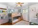 bedroom with wood bunk bed, wall shelving, and two windows providing ample natural light at 7216 S Lincoln Way, Centennial, CO 80122