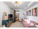 Basement flex space with pink couch, storage, and natural light provides a comfortable versatile area at 7216 S Lincoln Way, Centennial, CO 80122