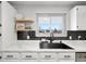 Kitchen sink with black faucet, marble countertops, and modern backsplash at 7216 S Lincoln Way, Centennial, CO 80122