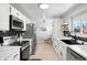 Modern kitchen with stainless steel appliances, ample cabinet space, and a cozy dining area at 7216 S Lincoln Way, Centennial, CO 80122