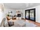 Cozy living room features a modern fireplace, black-framed French doors, and a comfortable sectional sofa at 7216 S Lincoln Way, Centennial, CO 80122