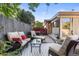 Relaxing patio with comfortable seating, a glass table, and views of the fenced backyard at 7216 S Lincoln Way, Centennial, CO 80122