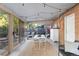 Inviting sunroom with string lights, large windows, and brick wall, offering an ideal space for relaxation at 7216 S Lincoln Way, Centennial, CO 80122