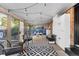 Bright sunroom with large windows, string lights, and comfortable seating, creating a relaxing atmosphere at 7216 S Lincoln Way, Centennial, CO 80122