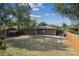 Fenced backyard has some dry grass and a small concrete patio at 3150 W Mexico Ave, Denver, CO 80219