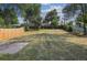Large backyard has a wood fence and some areas of dead grass at 3150 W Mexico Ave, Denver, CO 80219