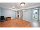 Open basement area with wood floors, leading to stairs, a closet and a bathroom at 3150 W Mexico Ave, Denver, CO 80219