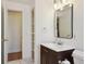 Bathroom includes a dark wood vanity, updated faucet, and storage space at 3150 W Mexico Ave, Denver, CO 80219
