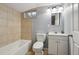 Basement bathroom features a shower/tub, toilet, and a single sink vanity at 3150 W Mexico Ave, Denver, CO 80219