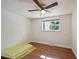 Spacious bedroom with hardwood floors, ceiling fan, and bright window providing natural light at 3150 W Mexico Ave, Denver, CO 80219