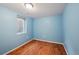 Bedroom features wood-look floors, blue walls, and one window at 3150 W Mexico Ave, Denver, CO 80219