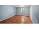 Bedroom features wood-look floors, blue walls, one window, and a closet with sliding doors at 3150 W Mexico Ave, Denver, CO 80219