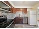 This kitchen is equipped with stainless steel appliances and stylish backsplash and countertops at 3150 W Mexico Ave, Denver, CO 80219