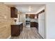 Modern kitchen featuring wood-paneled walls, stainless steel appliances, granite countertops, and hardwood flooring at 3150 W Mexico Ave, Denver, CO 80219