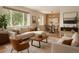 Bright living room featuring modern furnishings, large windows, hardwood floors, and an adjacent dining area at 3150 W Mexico Ave, Denver, CO 80219