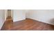 Inviting living room featuring hardwood floors, white walls, and natural light from a window at 3150 W Mexico Ave, Denver, CO 80219