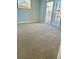 Bedroom showing neutral carpet, sliding glass doors to private deck for relaxing outdoor living at 7440 S Blackhawk St # 207, Englewood, CO 80112